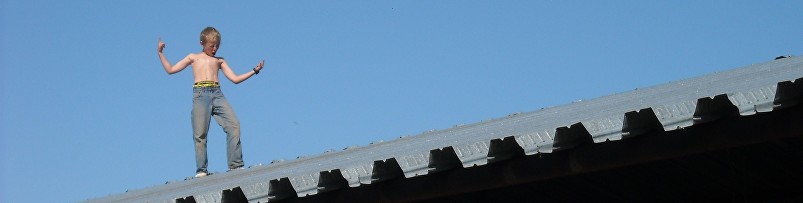 Matti Martin standing barefoot on a roof at Diamond M Ranch